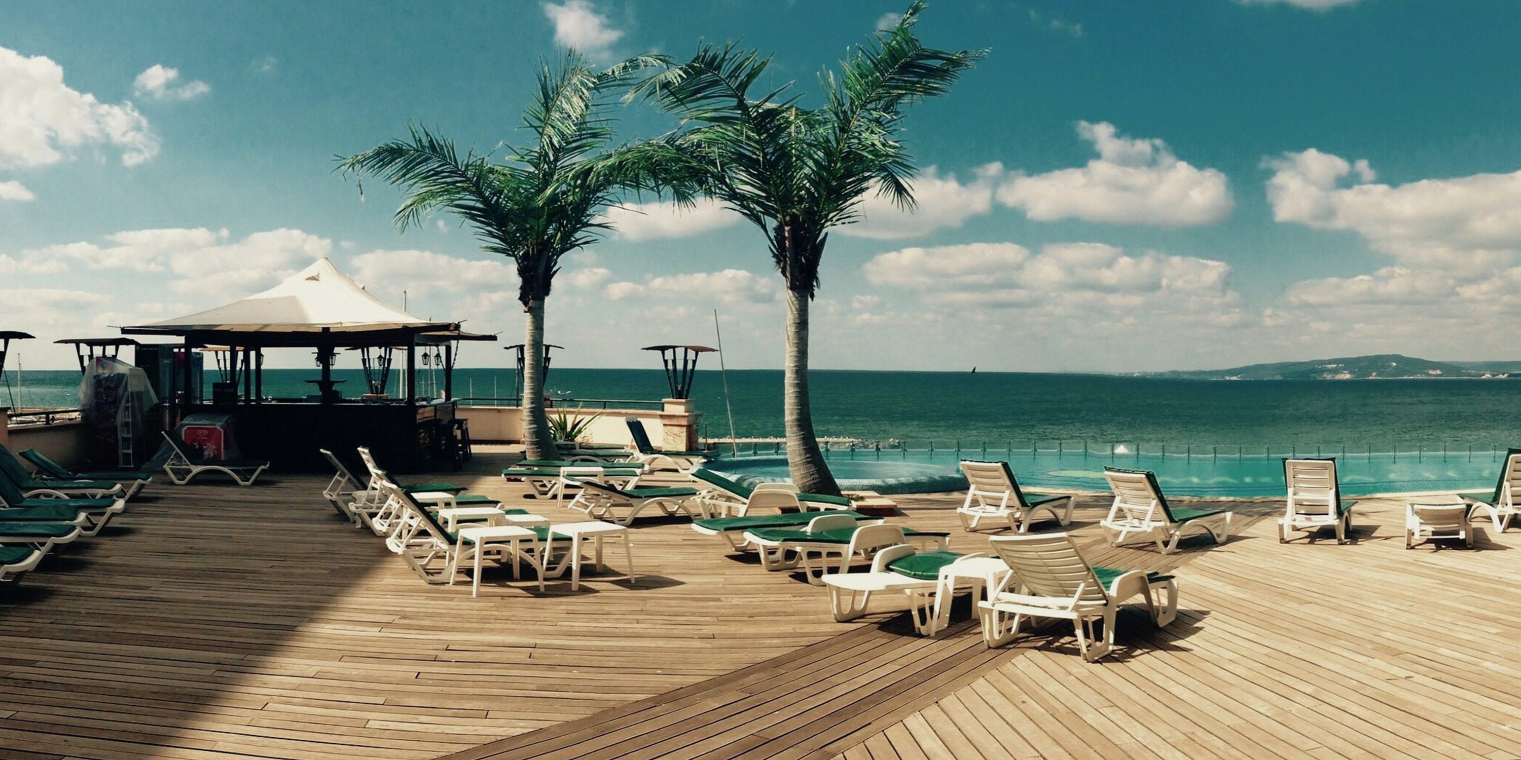 View of the ocean and palmtrees from a beach resort