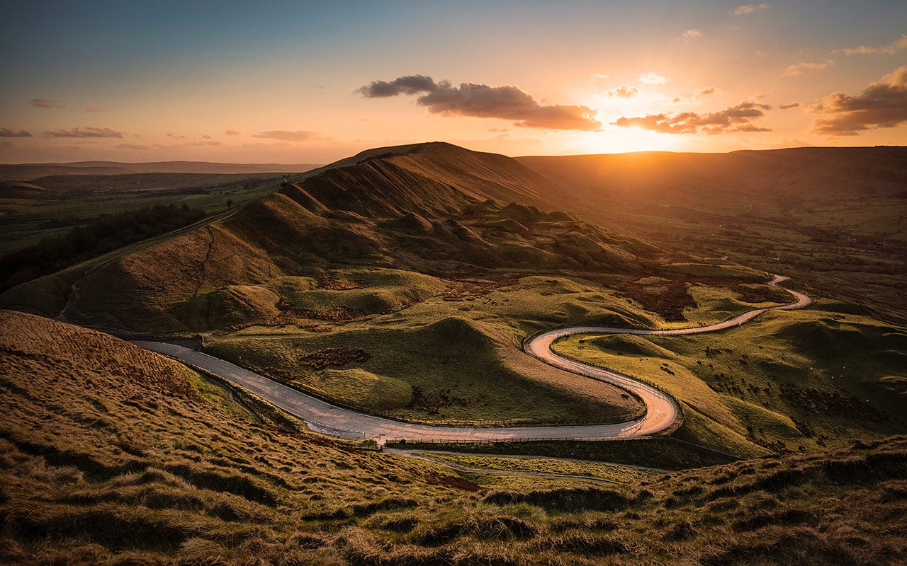 Sunset over mountains and road