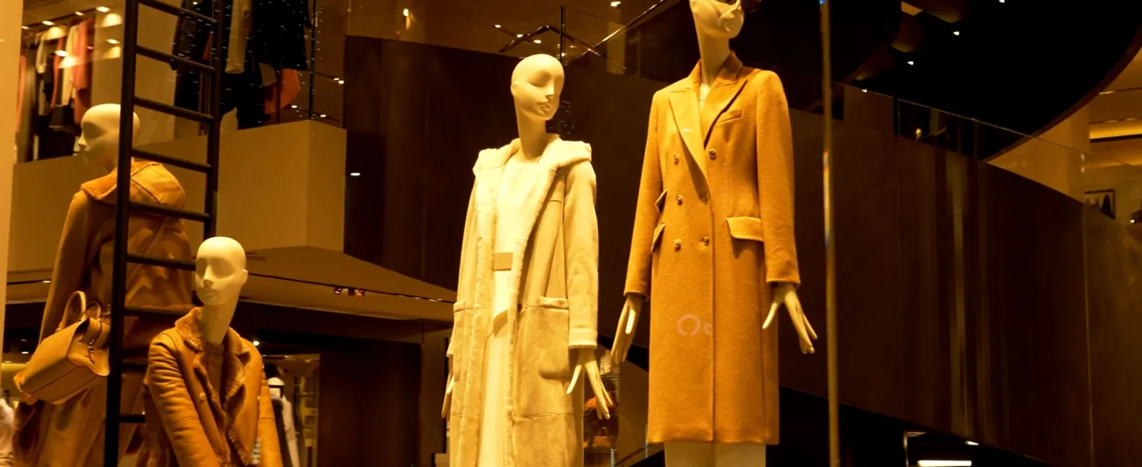 Stylish mannequins displayed in mall storefront