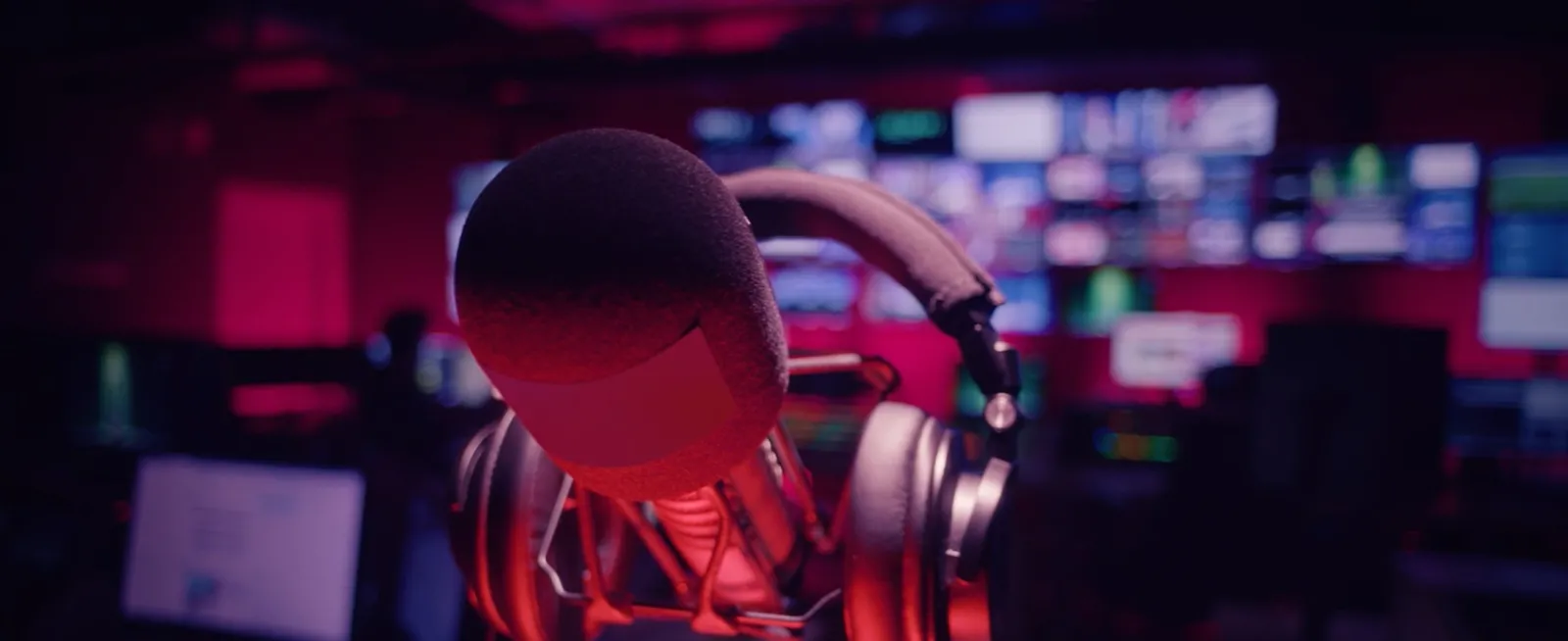 Closeup up mic and headphones with recording studio in background